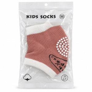 Chaussettes enfant rose et écru en sachet, picots antidérapants blancs sous le pied, taille M