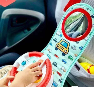 Enfant qui tourne le volant sonore HUANGER installé face à lui dans la voiture