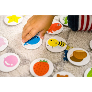 Gros plan sur les jetons illustrés Nathan : baleine bleue, abeille jaune, fraise rouge, poisson orange