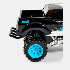 Détail de l'amortisseur à ressort et du pneu cranté du monster truck RC Wild Monster