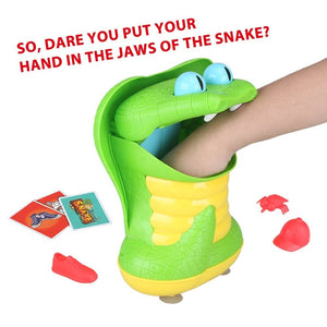 Main d'enfant qui retire un objet de la gueule du Greedy Snake