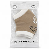 Chaussettes enfant beige et écru en sachet, picots antidérapants blancs sous le pied, taille M